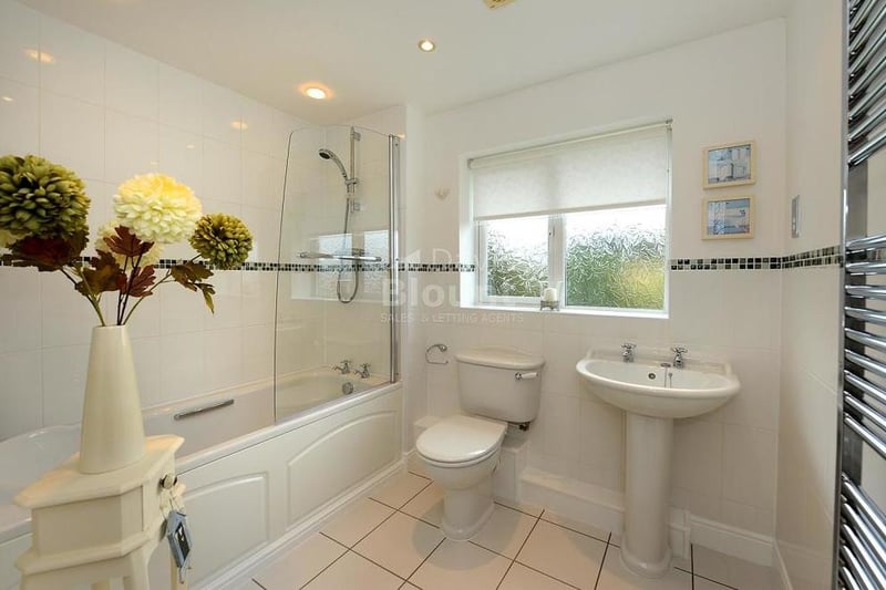 Here is the family bathroom, which consists of a panelled bath, wash hand basin and WC. There is a mains shower above the bath, while a chrome radiator adorns the wall.