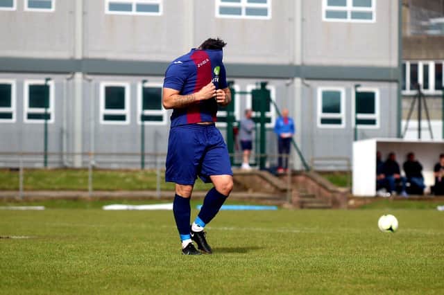 Jack Chandler covers his face after seeing his penalty saved by Binfield's Chris Grace. Picture: Tom Phillips.