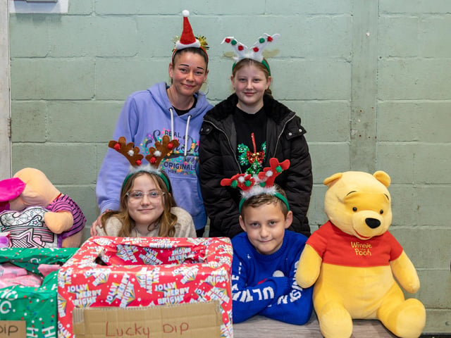 Members of the Brittan family running the lucky dip and tombola stall at the Fratton Christmas Fair. Picture: Mike Cooter (091223)