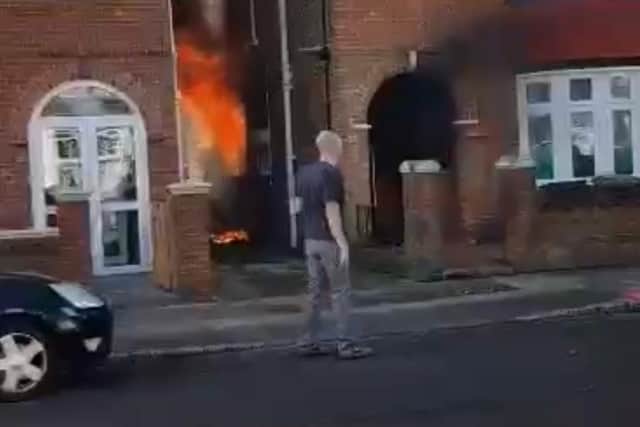 Daniel Wakelin, 44, pictured retreating from the blazing home in Torrington Road, North End, after valiantly attempting to break in and rescue a 101-year-old woman who was trapped inside.