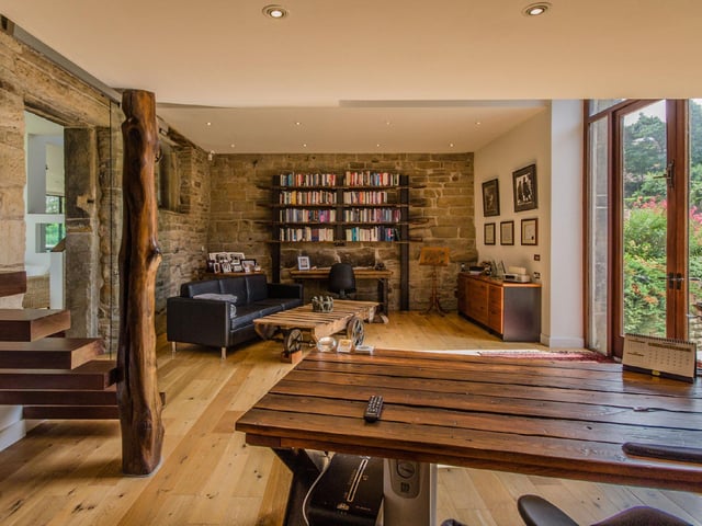 A cosy office space sits in the west wing of the original barn, which is flooded by an abundance of natural light from the arched windows and boasts views over the courtyard.