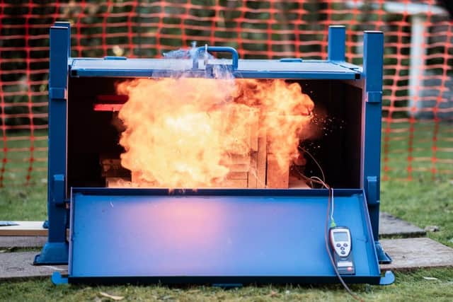 BLAZE: A mobile phone which has burst into flames because of a faulty lithium-ion battery. Barnbrook Systems and Flair's E:BAG can safely and quickly deal with such fires
