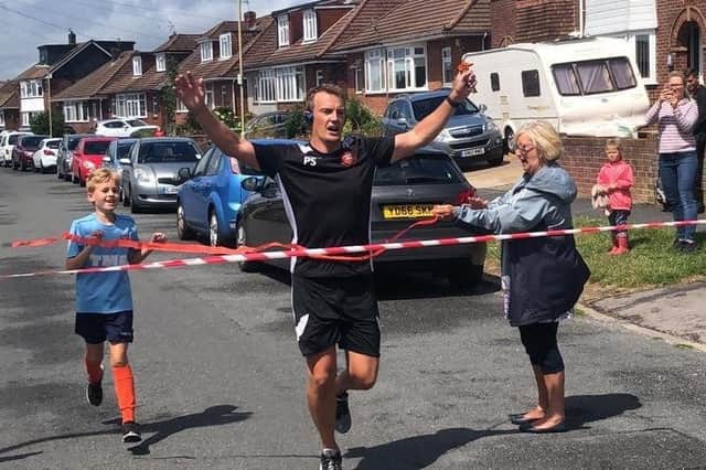 Peter Sanderson completes his street marathon to raise money for AFC Portchester's youth football teams in 2020.