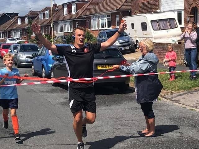 Peter Sanderson completes his street marathon to raise money for AFC Portchester's youth football teams in 2020.