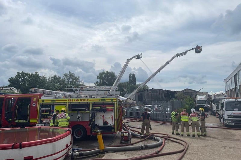 More than 80 firefighters were deployed to tackle a ferocious garage fire, which spread to nearby vehicles and buildings. Smoke could be seen filling the sky.
