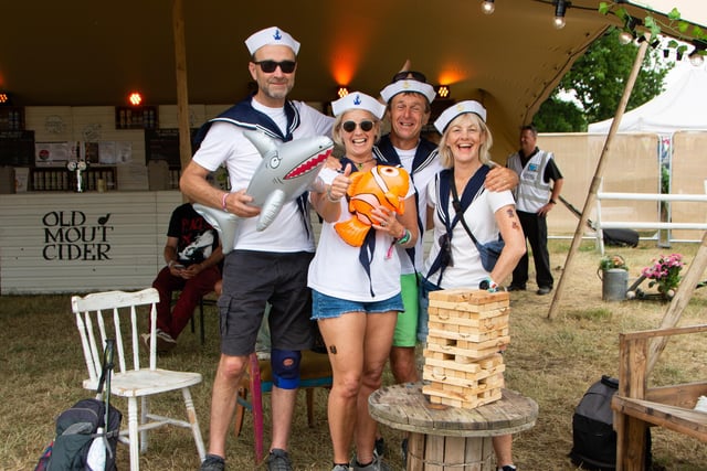 Karen and Alastair Bateman and Vicky and Mike Reed play Jenga in the Old Mout Cider Tent, Isle Of Wight Festival 2022.