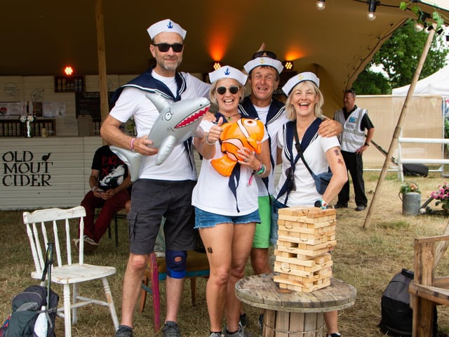 Karen and Alastair Bateman and Vicky and Mike Reed play Jenga in the Old Mout Cider Tent, Isle Of Wight Festival 2022.