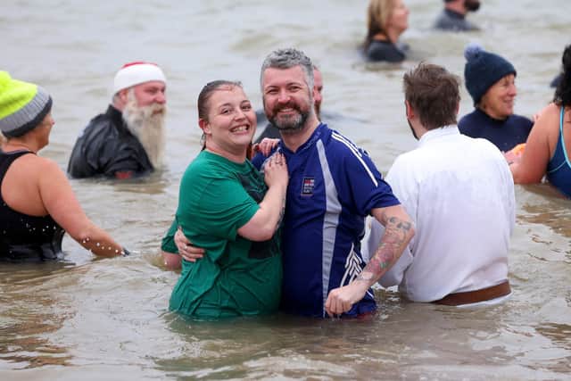 The 2023 Gafirs New Years Day Dip, an annual New Year's Day dip in the Solent. Pictured is action from the event.

Pictured is Beckie Pownall and Carl Pinnock.

1st January 2023

Photograph by Sam Stephenson, 07880 703135, www.samstephenson.co.uk.