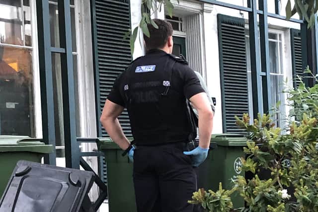 Police outside a home in Kingston Crescent which witness report was raided by officers, who removed a number of 'large brown bags' from inside. Photo: Tom Cotterill