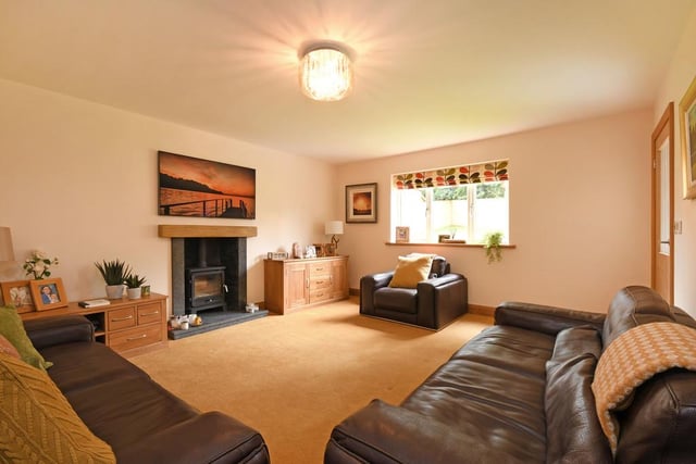 A "lovely, cosy room" with the focal point being a traditional log-burning stove.