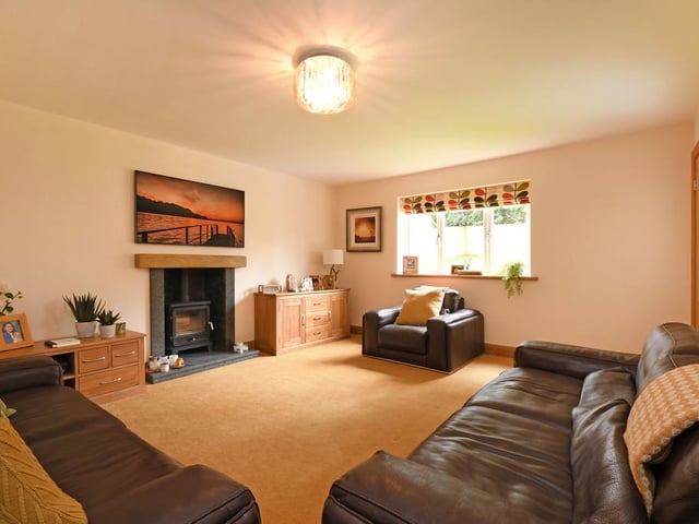 A "lovely, cosy room" with the focal point being a traditional log-burning stove.