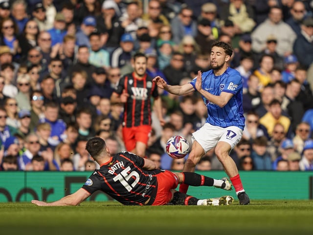 Blackburn Rovers defender Danny Batth tackles Pompey forward Adil Aouchiche as the Fratton faithful watch on from the stands.