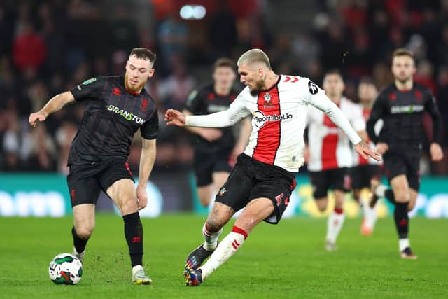 SOUTHAMPTON, ENGLAND - DECEMBER 20: Ben House of Lincoln City FC battles for the ball with Lyanco of Southampton FC during the Carabao Cup Fourth Round match between Southampton and Lincoln City at St Mary's Stadium on December 20, 2022 in Southampton, England. (Photo by Bryn Lennon/Getty Images)