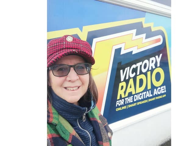 Loree Westron, founder of Portsmouth Authors Collective, outside Victory Radio studios