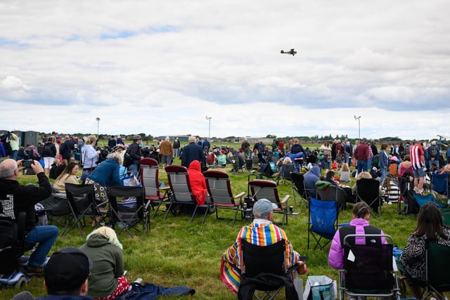 Pictured is: Visitors to the show watch and aircraft displayPicture: Keith Woodland (080621-105)