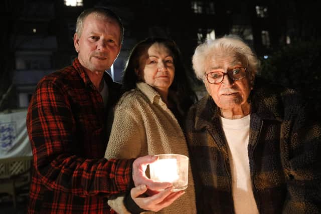 David and Joanna White and Joanna's father, John Castleton, use candles to make a Beacon of Remembrance in Grosvenor St, Southsea 
Picture: Chris Moorhouse      (230321-33)