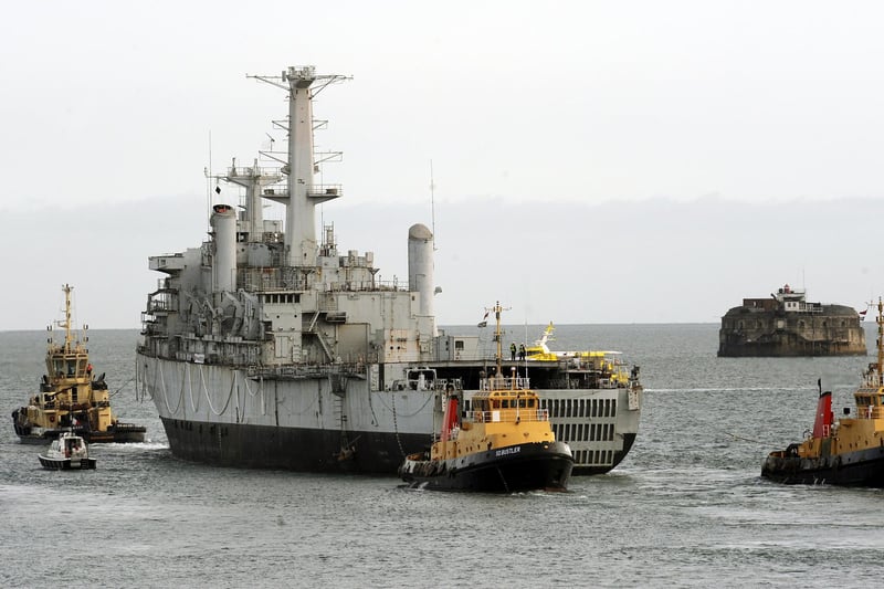 12th September 2008 Falkland's veteran Royal Navy assault ship HMS Intrepid being towed by Portsmouth naval base tugs, past the Round Tower at Old Portsmouth, as former crew members and well wishers see the ship leave harbour for the last time. The News 083744-0232