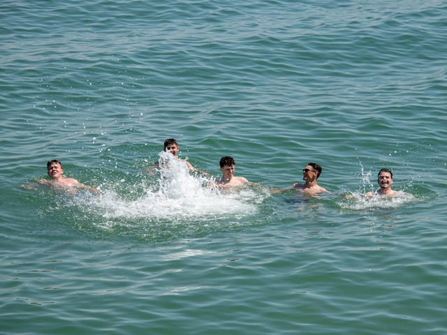 Pictured: Friends enjoying a splash in the sea in Southsea.