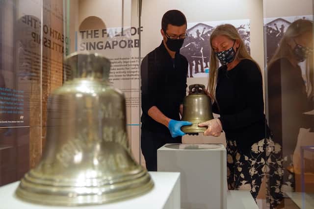 Victoria Ingles, senior curator at the National Museum of the Royal Navy, and Will Heppa move the ship's bell from HMS Repulse which was sunk along with HMS Prince of Wales after a Japanese air attack on December 10 1941. 842 men lost their lives in what is one of the worst disasters in British naval history. Picture date: Wednesday December 8, 2021.