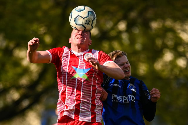 Clanfield's Olly Long, right, is beaten in the air. Picture by Richard Murray