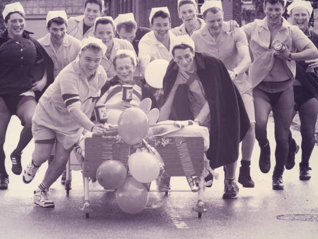 Weapons Engineering Mechanics from HMS Collingwood take charge with a charity bed push from Wykeham day Hospital to Fareham, 1993. The News PP5532