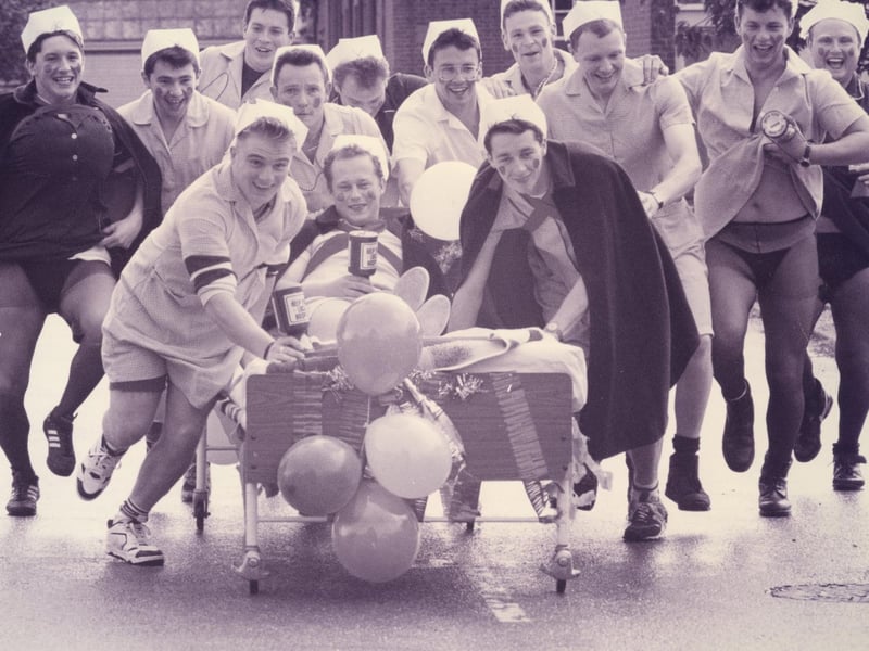 Weapons Engineering Mechanics from HMS Collingwood take charge with a charity bed push from Wykeham day Hospital to Fareham, 1993. The News PP5532