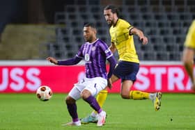 Christian Burgess battles with Toulouse's Yanis Begraoui in Europa League action last month. Picture: VIRGINIE LEFOUR/BELGA/AFP via Getty Images