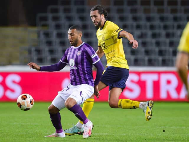 Christian Burgess battles with Toulouse's Yanis Begraoui in Europa League action last month. Picture: VIRGINIE LEFOUR/BELGA/AFP via Getty Images