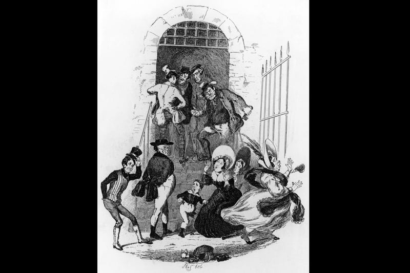 Sam Weller (right) and Samuel Pickwick (second from right) meet Pickwick's widowed landlady Mrs Bardell at Fleet Prison in a scene from Charles Dickens's first novel 'The Pickwick Papers', published as a serial from 1836 to 1837. Illustration by Phiz (Hablot Knight Browne, 1815 - 1882). (Photo by Hulton Archive/Getty Images)