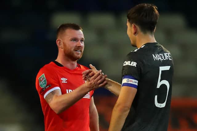 Pompey signing Ryan Tunnicliffe talks to Manchester United's Harry Maguire after Luton's Carabao Cup defeat to the Premier League side last season. Picture: Catherine Ivill/Getty Images