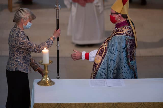 Bishop Christopher hands over his crozier to synod lay chair Debbie Sutton, who will lay it on the cathedral altar, marking the end of his tenure as Bishop of Portsmouth.