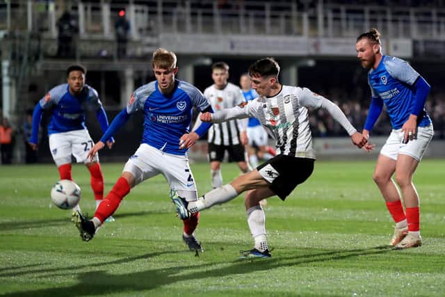 Pompey's Zak Swanson tries to block Ryan McLean's cross during the FA Cup first-round encounter. Picture: Bradley Collyer/PA Wire.