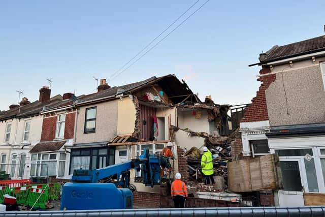 A work crew is onsite to make the front of the collapsed building as safe as possible to the public.