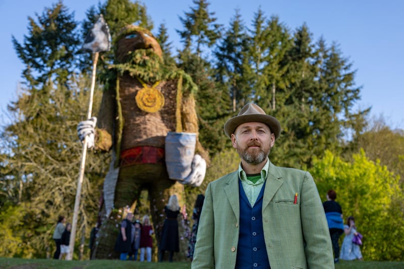 Environmental artist Mark Antony Haden Ford stands in front of the wickerman he created for the Beltain celebrations at Butser Ancient Farm.