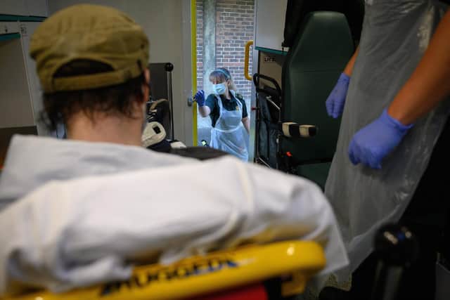 Newly-qualified paramedic Nikki Philpott opens the ambulance door after transporting a patient who has previously tested positive for the Covid-19 virus to the Queen Alexandra Hospital, on May 6, 2020 in Portsmouth. Picture: Leon Neal - Pool/Getty Images
