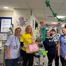 Children and parents at Queen Alexandra Hospital received a welcome delivery of 40 perfect pizzas in the run-up to Christmas.
Pictured: Families, healthcare workers, staff at the Tesco Whiteley Superstore, volunteers from the Eight Foundation at Queen Alexandra Hospital and the team at Sophie's Legacy.