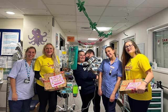 Children and parents at Queen Alexandra Hospital received a welcome delivery of 40 perfect pizzas in the run-up to Christmas.
Pictured: Families, healthcare workers, staff at the Tesco Whiteley Superstore, volunteers from the Eight Foundation at Queen Alexandra Hospital and the team at Sophie's Legacy.