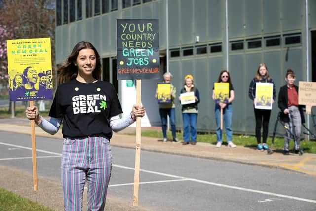 Lisa Bruni, left, and fellow campaigners queue outside the Job Centre on Elmleigh Rd, to call on their Conservative MP, Alan Mak, to support investment in green jobs in Havant. Picture: Chris Moorhouse