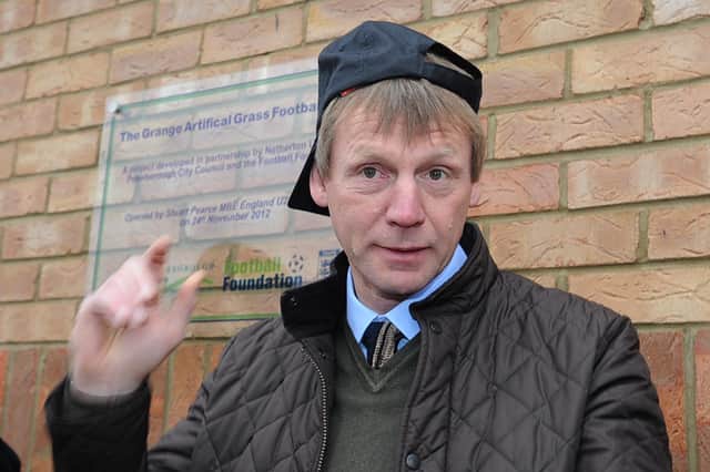 England U21 manager Stuart Pearce poses with a Netherton United cap at The Grange, Netherton, after officially opening the new synthetic pitch.