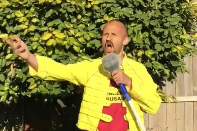 Neil Smith does his best Freddie Mercury impression prior to taking part in the relay.