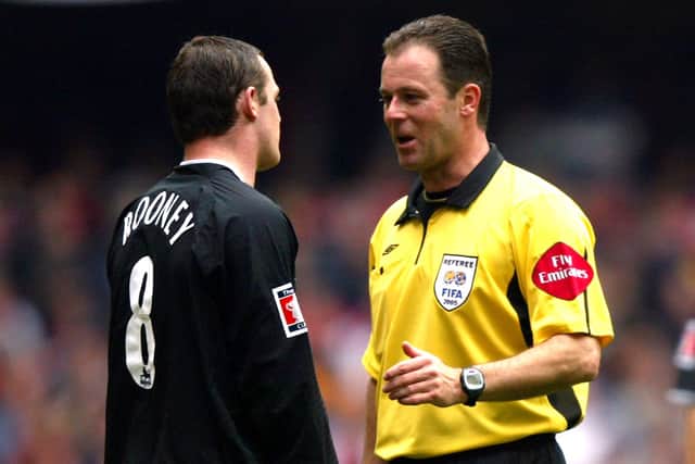 Rob Styles has a word with Manchester United's Wayne Rooney. Picture: Mike Egerton/EMPICS Sport