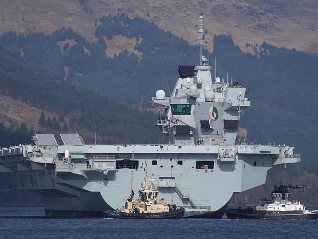 The Royal Navy aircraft carrier HMS Queen Elizabeth leaving Glen Mallan in Loch Long with the Arrochar Alps behind. Picture: Andrew Milligan/PA Wire