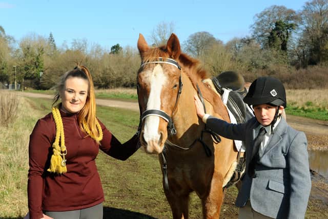 Freddie Tyler-Fowlie (11) from Leigh Park, has learned how to speak through his horse Drift. Pictured is Freddie with Drift and his mum Carla Fowlie (35). Picture: Sarah Standing (090321-4615)