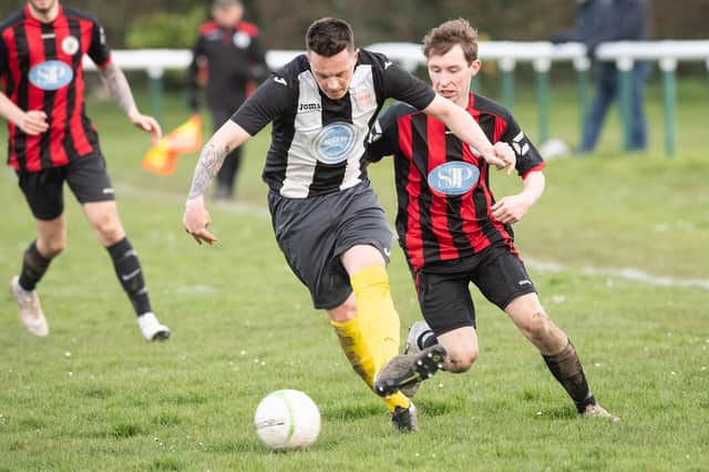 Luke Wheatcroft (black/white) is one of a handful of players who can play as a centre half in Hayling's squad. Picture: Keith Woodland