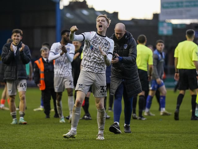 Paddy Lane celebrates in front of the travelling Fratton faithful at the final whistle