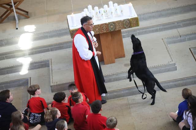 The Bishop of Portsmouth, the Rt Rev Jonathan Frost, and his labrador Bonnie during the Leavers Service in Portsmouth Cathedral