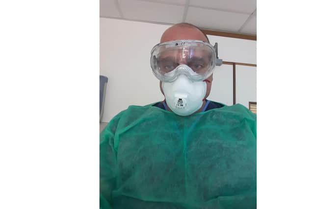 John Arnell, pictured working in PPE during Covid.