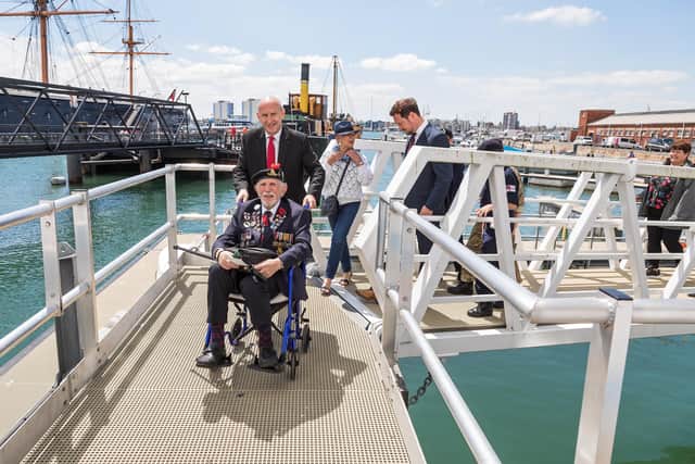 John Healey (Shadow Secretary of State for Defence) lends a hand pushing D-Day veteran Joe Cattini (98) up the ramp at Portsmouth Naval Base on Armed Forces Day. Picture: Mike Cooter (250621)