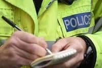 Police officer takes notes.