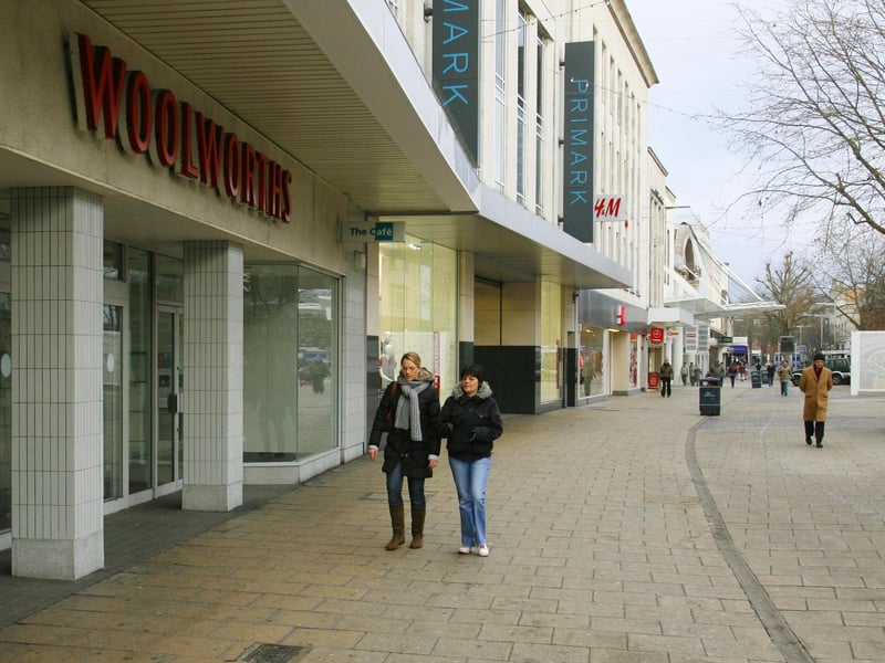 Shoppers walk past a closed Woolworths store in Commercial Road in central Portsmouth January 5, 2009.